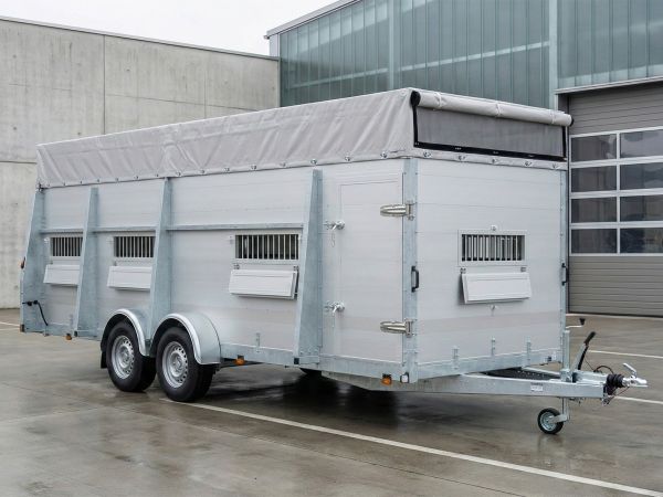 Professioneller Viehtransporter-Anhänger in stabiler Aluminiumbauweise mit Tandemachse, Planenverdeck und Belüftungssystem für den sicheren Tiertransport